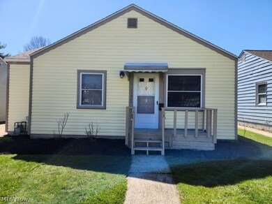 Bungalow-style home with a front yard