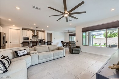 Living room with a ceiling fan, light tile pattern