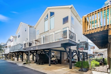 Rear view of property featuring a carport, a residential view, and a deck