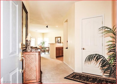 Entryway featuring light colored carpet and basebo