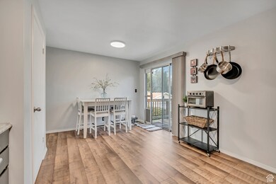 Dining room with light wood-style flooring and baseboards