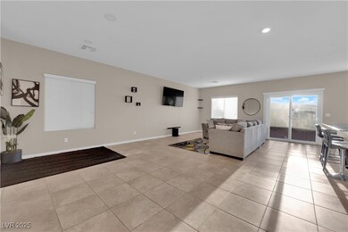 Living room with baseboards, visible vents, and li