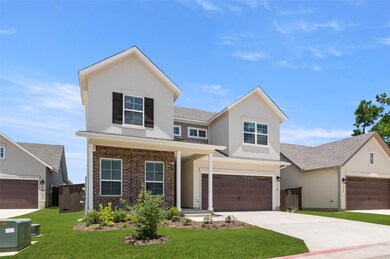 Traditional home featuring stucco siding, a front