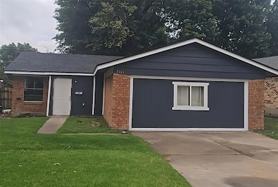 Ranch-style home with brick siding, a front yard, and concrete driveway
