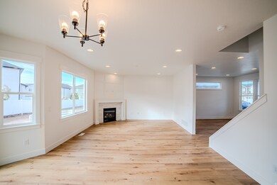Unfurnished living room featuring recessed lighting, light wood-type flooring, a chandelier, and a fireplace