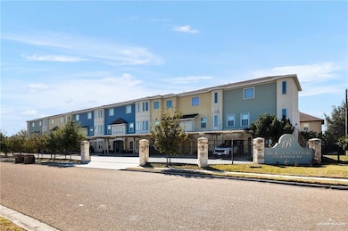 View of building exterior featuring a residential view and fence