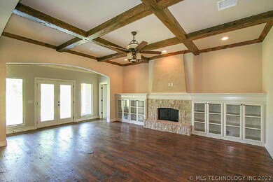 Den built in cabinets, beamed ceiling, stone firep