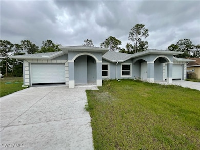 Ranch-style home featuring a front yard, an attach