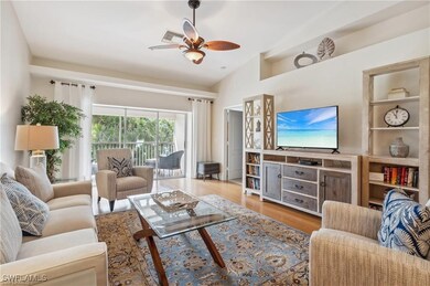 Living room with lofted ceiling, wood-type flooring, and ceiling fan