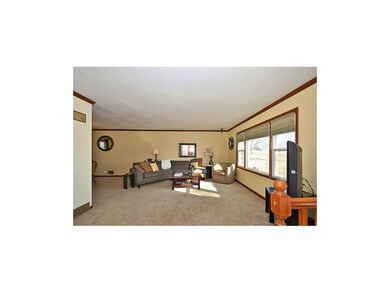 Beautiful living room is light and bright. Open to