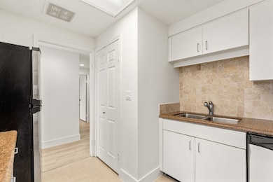Kitchen with utility closet to left of sink with s