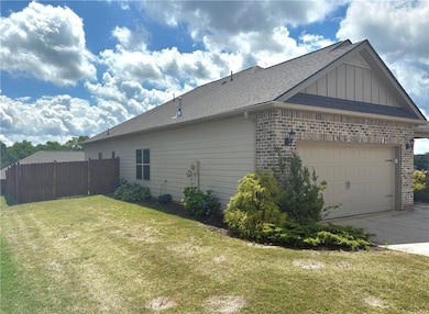 View of side of home with brick siding, board and 