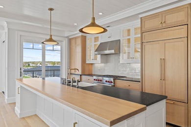 Central island with quartz counter tops provide th