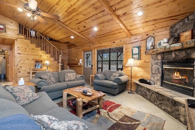 Living area featuring beam ceiling, a fireplace, w
