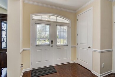 Double doors open to the foyer.