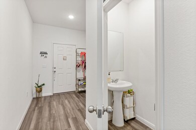 Entrance foyer with dark wood-type flooring and recessed lighting