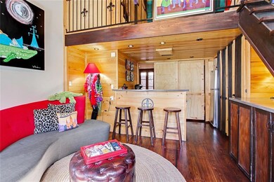 Kitchen overlooks the living area with a bar top f