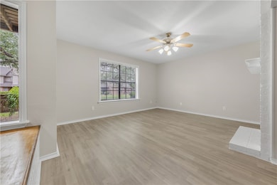 Unfurnished living room with a ceiling fan, basebo