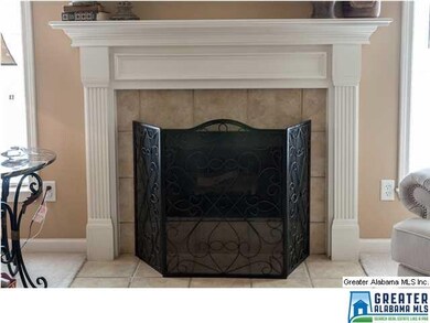Fireplace is gas-log with tile and wood accents.