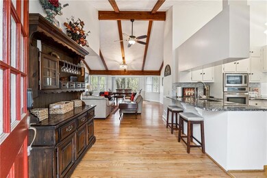 Kitchen with dark stone countertops, a sink, white