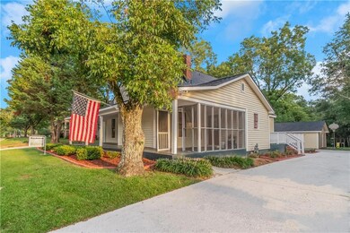 View of home's exterior with a yard and screened-i