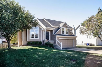 View of front facade with concrete driveway, an attached garage, and a shingled roof