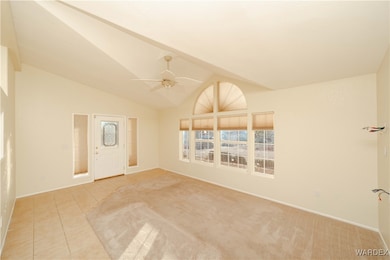 Unfurnished room featuring ceiling fan, lofted cei