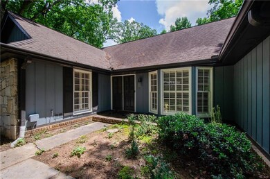Doorway to property featuring roof with shingles