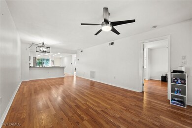 Unfurnished living room featuring wood-type floori