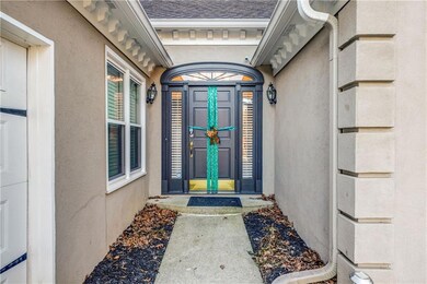 Entrance to property featuring stucco siding and roof with shingles