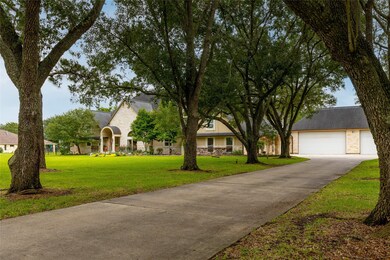 Towering oak trees line either side of the lengthy driveway, creating a shade canopy all the way to the oversized 3 car garage with an extra high 10' ceiling, built-in workshop, wall a/c unit, and a rear bay door access. Bring your boat or RV - there are no HOA restrictions!