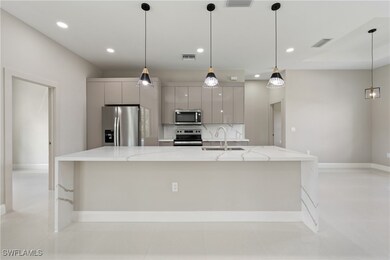 Kitchen with a sink, visible vents, gray cabinets,