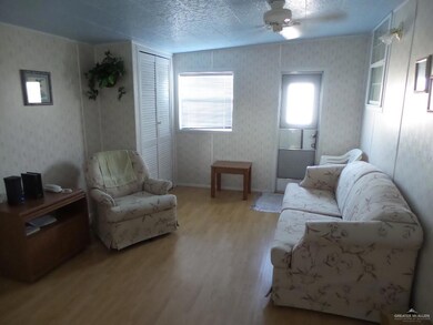 Living area with laminate floor and front closet area. Sells fully furnished.