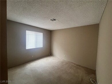Carpeted spare room featuring a textured ceiling