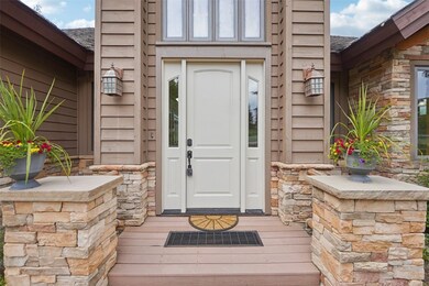 View of exterior entry featuring stone siding and