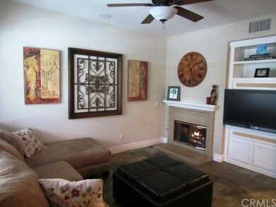 Living room with gas fireplace, media area, ceilin