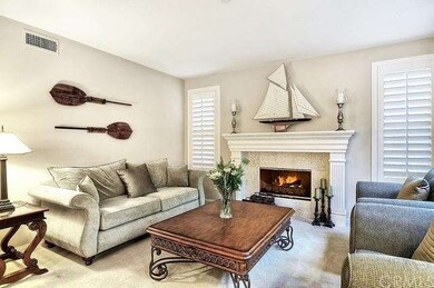 The living room is adorned with a cozy fireplace a