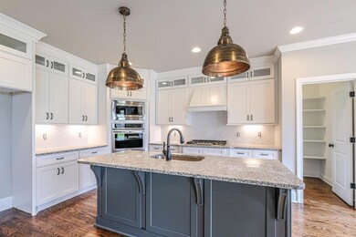 Kitchen has granite, stainless appliances, gas cooktop, entertainment island and eat-in area.