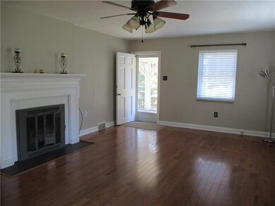Living room with view of gas fireplace and screene