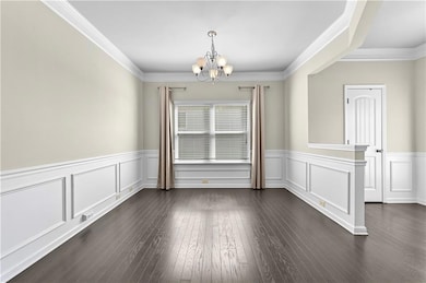 Unfurnished dining area with crown molding, a chan