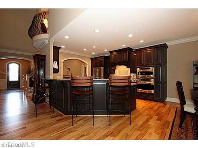 Kitchen. Note loft balcony that over looks Den at upper left of photo.
