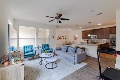 Living room with ceiling fan, dark wood finished 