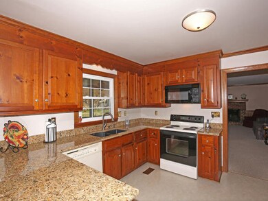The spacious eat-in kitchen has beautiful granite 