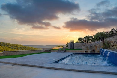 Pool at dusk with a fenced backyard, a patio, and