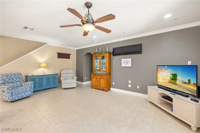 Living area with baseboards, ornamental molding, a