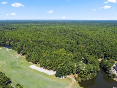 Aerial view of property and surrounding area with a large body of water and a local golf course
