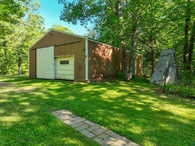 Exterior space with a garage and an outdoor struct