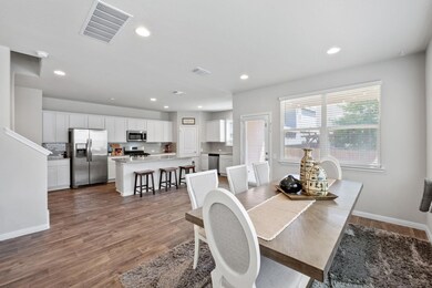 Dining space featuring dark wood-style flooring a