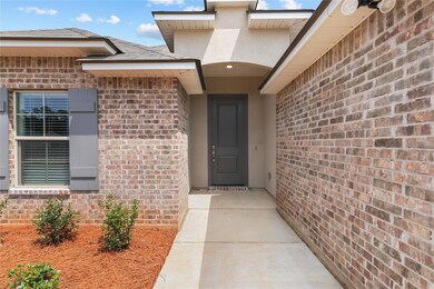 View of exterior entry with brick siding