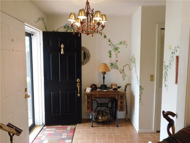 Entry has beautiful doors, chandelier, and incredi